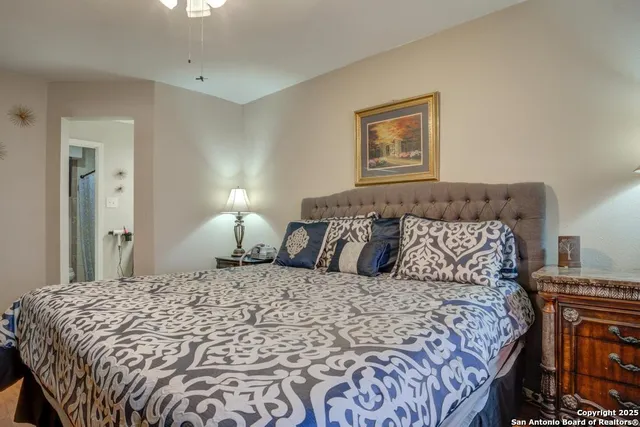 a bedroom with a large bed and a lamp