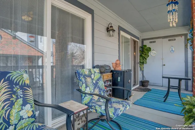 a balcony with furniture and wooden floor