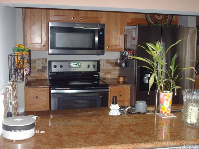 a kitchen with a stove and a wooden floor