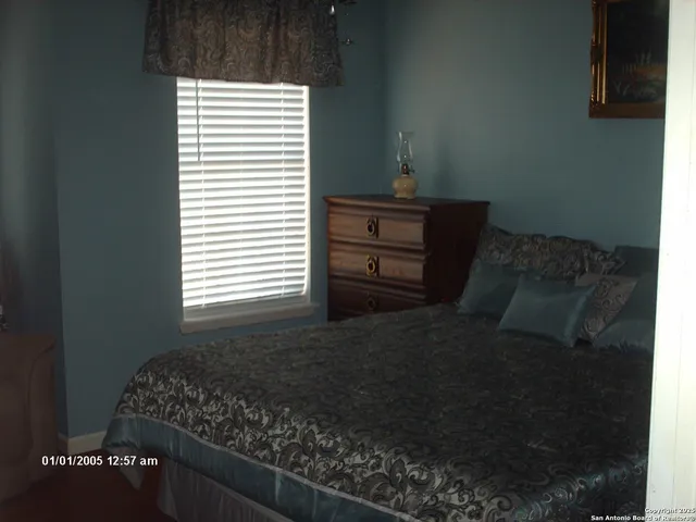 a bed sitting in a bedroom next to a window