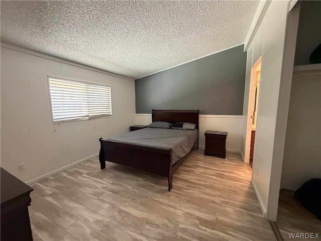 1910 Rio Grande Road Bullhead City, AZ 86442 - Photo 15 of 29 Room featuring light wood-finish flooring and a textured ceiling