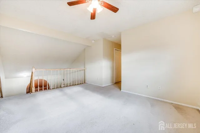 an empty room with painted walls and chandelier