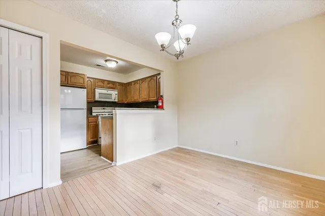 a view of a kitchen with a microwave and wooden floor