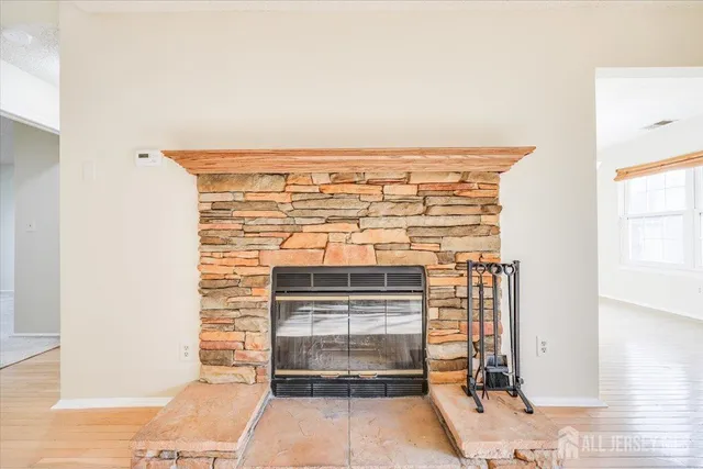 a view of an empty room and fire place