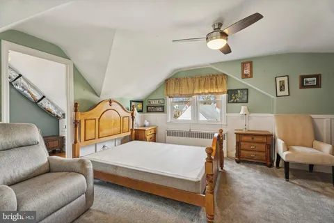 a living room with furniture a fireplace and a chandelier