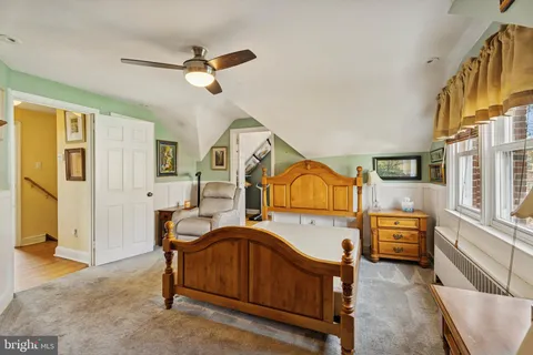 a bedroom with furniture and a wooden floor