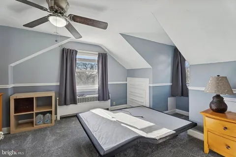 a bedroom with a bed and a fireplace