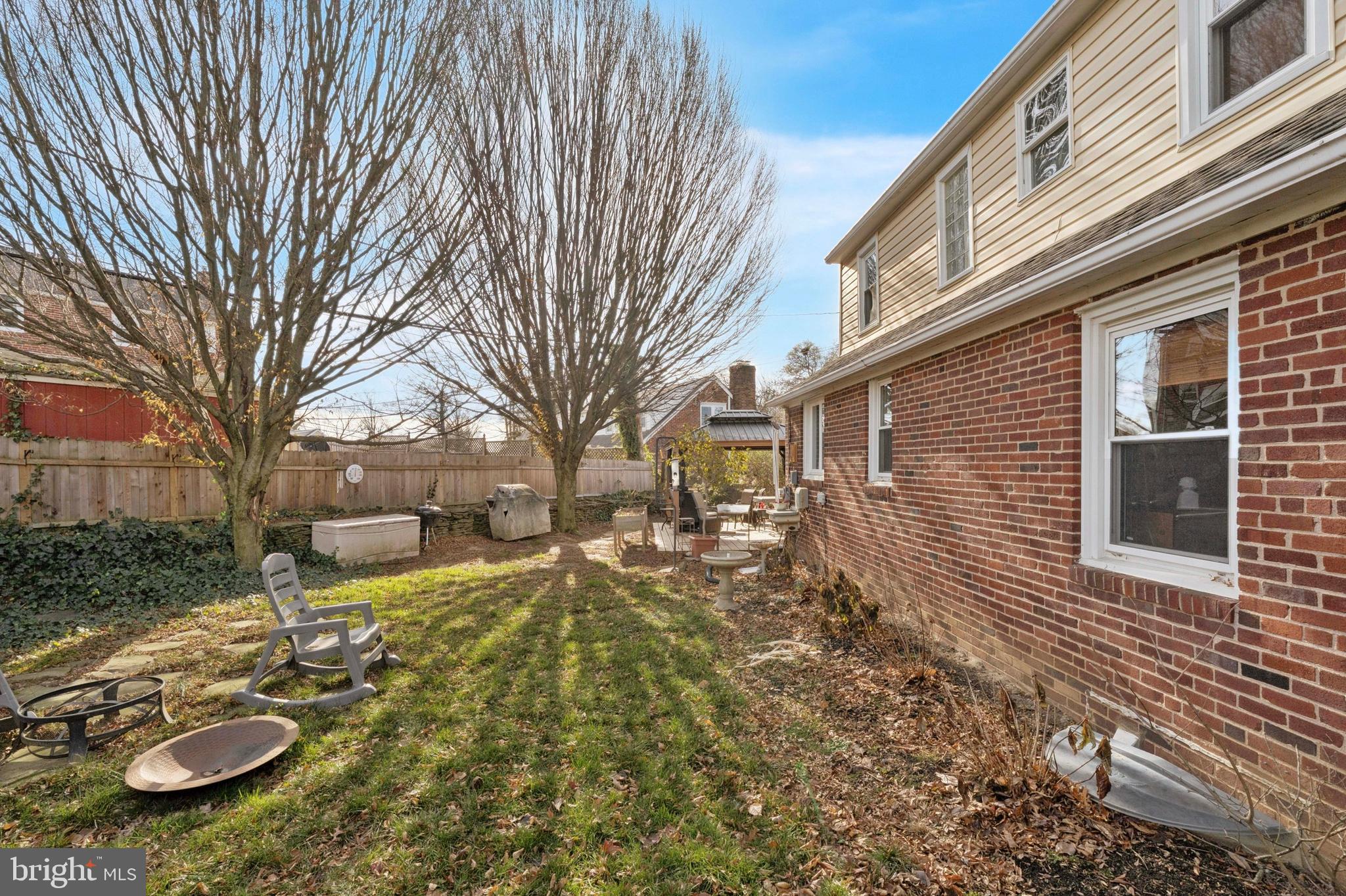 145 Merrybrook Drive Havertown, PA 19083 - Photo 28 of 29 a view of a backyard with table and chairs under an umbrella
