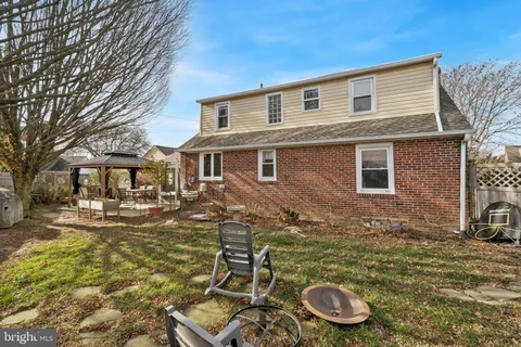 a front view of a house with yard and seating