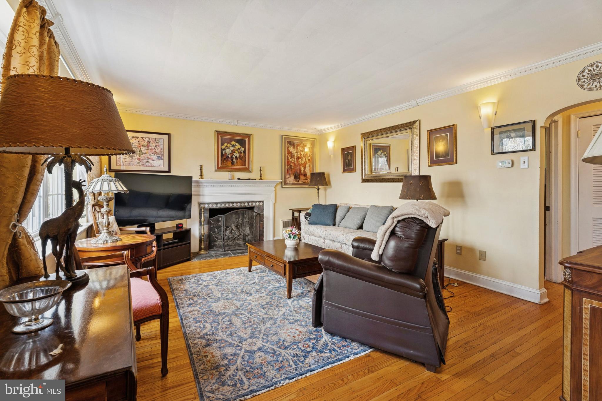 145 Merrybrook Drive Havertown, PA 19083 - Photo 3 of 29 a living room with furniture a flat screen tv and a fireplace