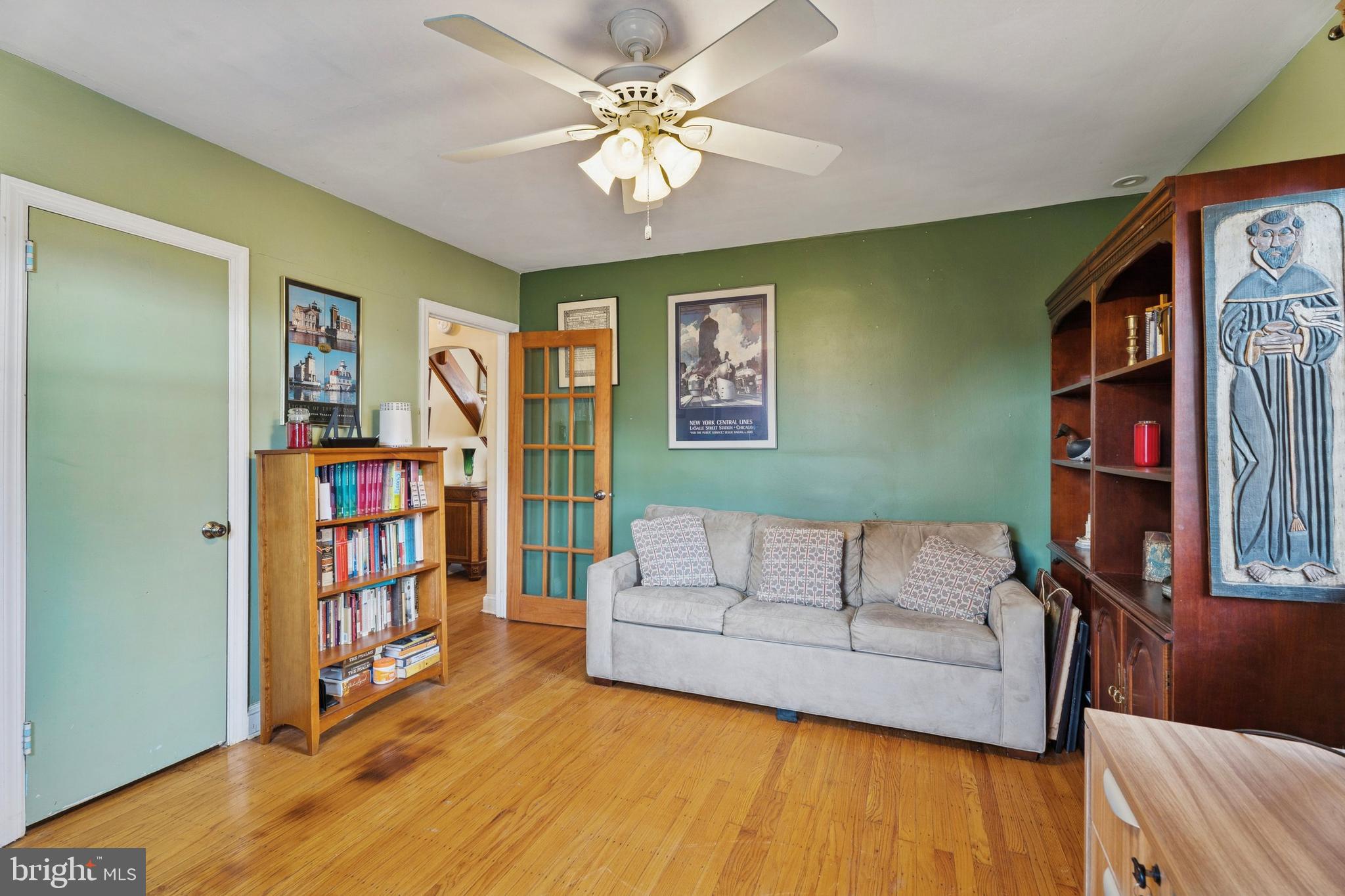 145 Merrybrook Drive Havertown, PA 19083 - Photo 6 of 29 a living room with lots of furniture and a book shelf