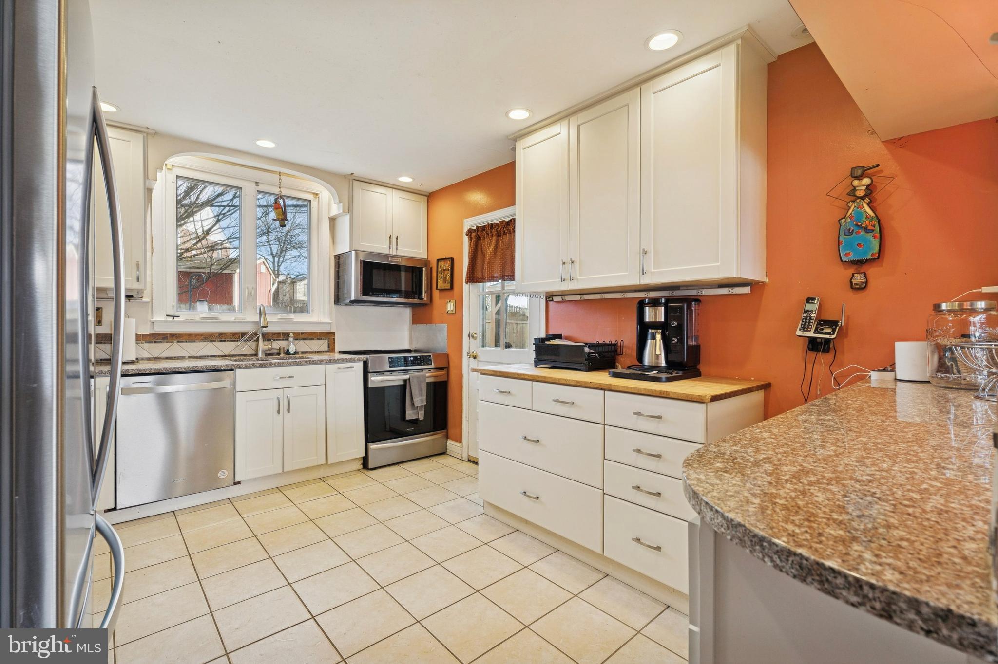 145 Merrybrook Drive Havertown, PA 19083 - Photo 10 of 29 a kitchen with white cabinets and appliances