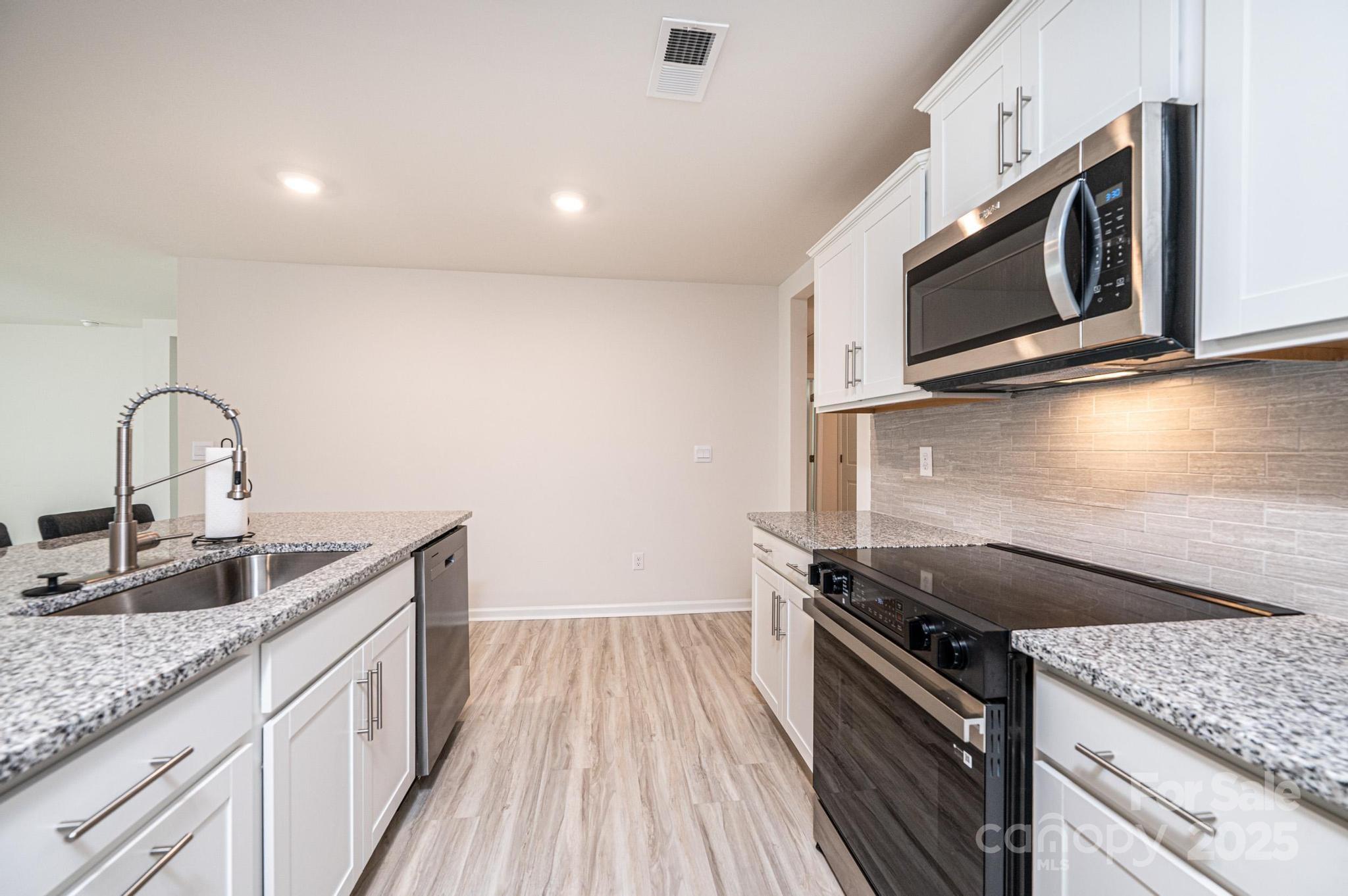 2542 Goose Fair Road Maiden, NC 28650 - Photo 16 of 48 a kitchen with stainless steel appliances granite countertop a sink stove and microwave