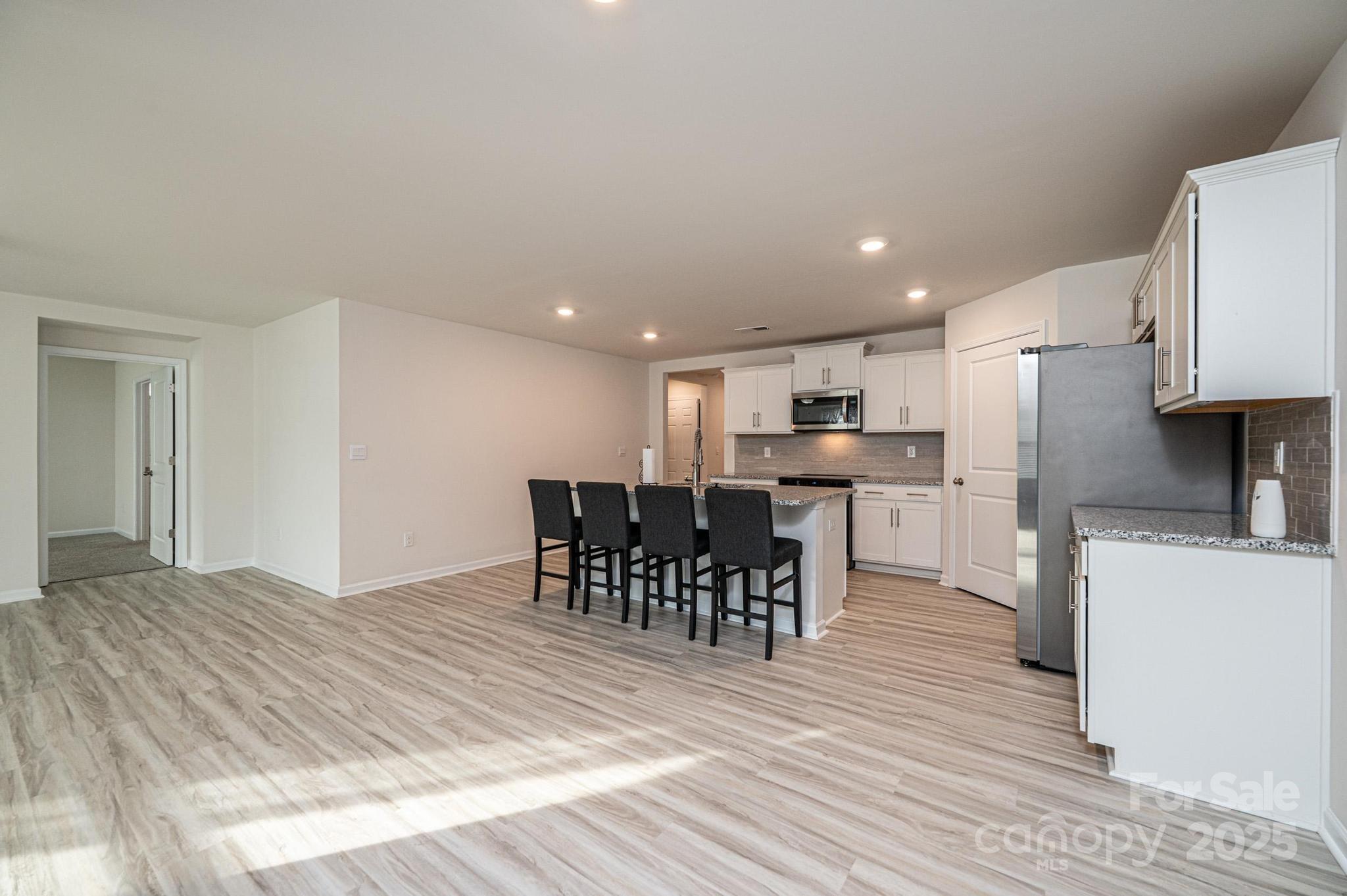 2542 Goose Fair Road Maiden, NC 28650 - Photo 20 of 48 a kitchen with stainless steel appliances kitchen island granite countertop a dining table chairs and a refrigerator