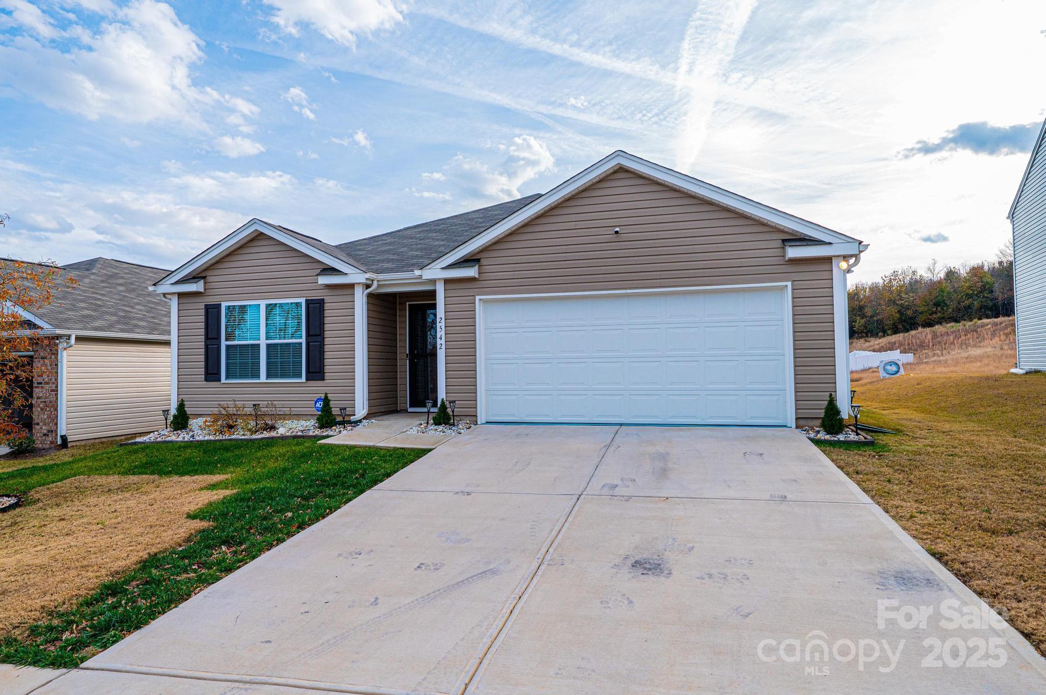2542 Goose Fair Road Maiden, NC 28650 - Photo 2 of 48 a front view of a house with a yard and garage
