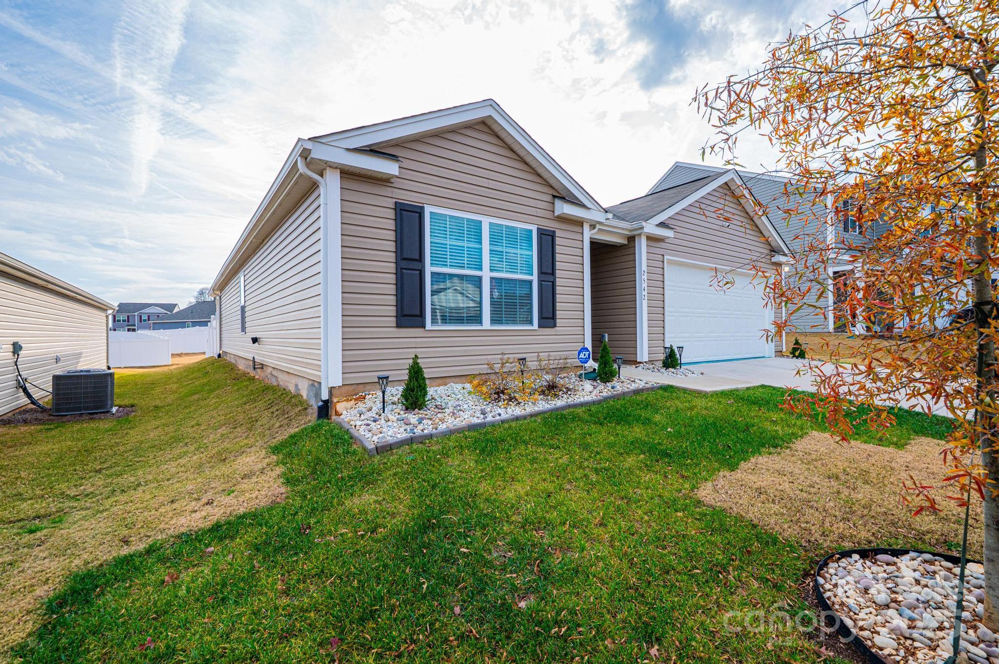 2542 Goose Fair Road Maiden, NC 28650 - Photo 3 of 48 a view of a white house next to a yard with big trees