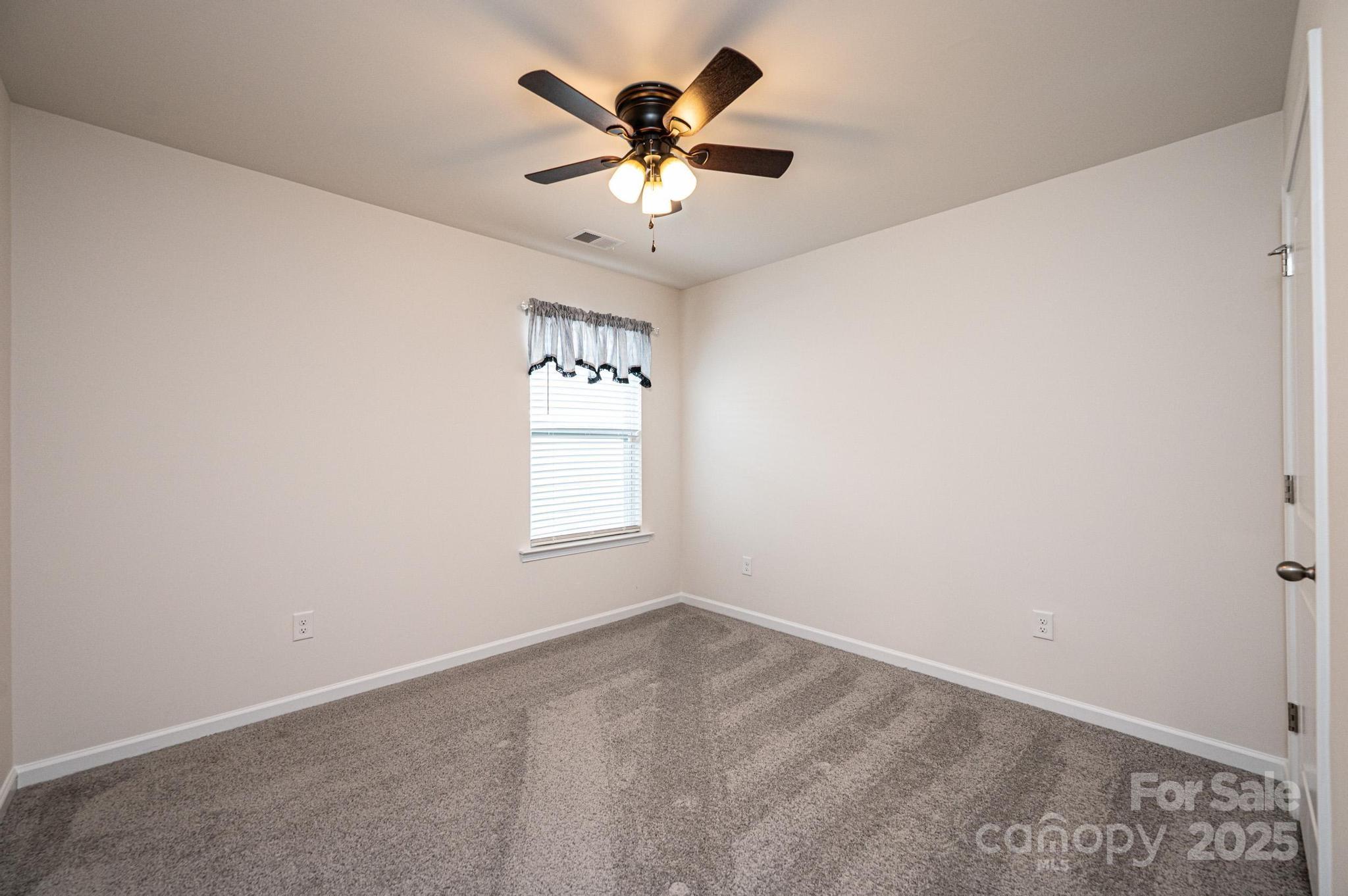2542 Goose Fair Road Maiden, NC 28650 - Photo 39 of 48 an empty room with windows and fan