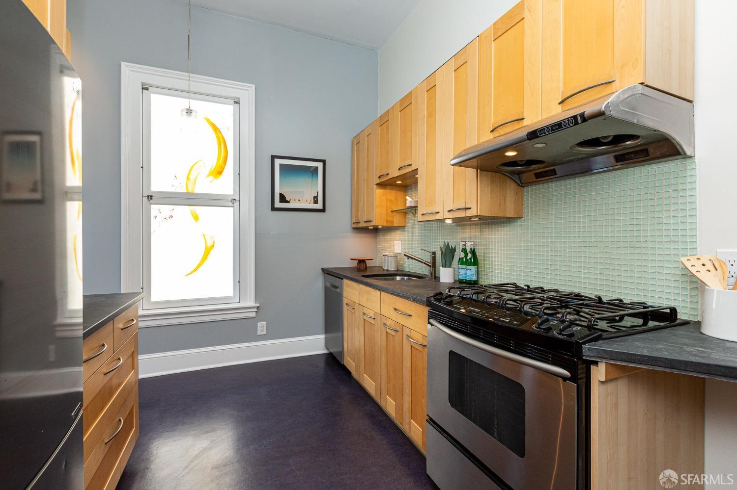 1429 Chestnut Street Oakland, CA 94607 - Photo 3 of 20 a kitchen with stainless steel appliances granite countertop a stove a sink and a microwave