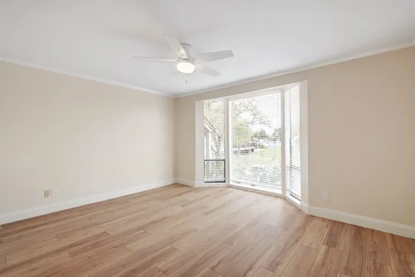 a view of an empty room with wooden floor