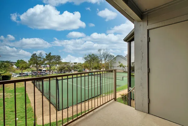 a view of a porch with chairs and a yard