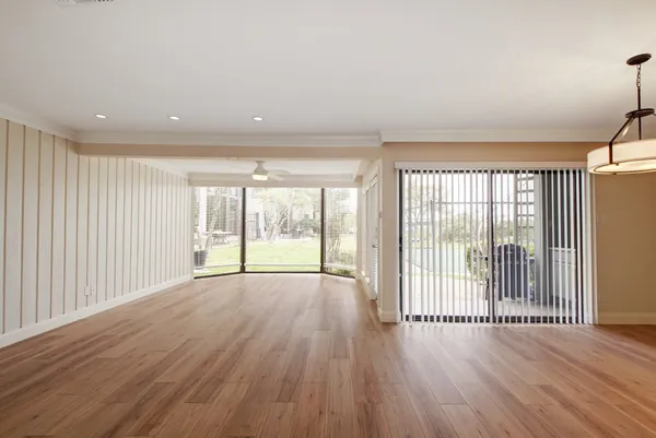 wooden floor in an empty room with a window