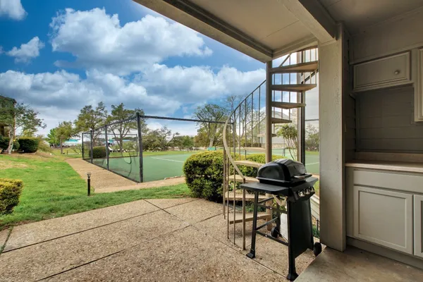 a view of a house with backyard and porch