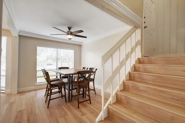 a view of a dining room with furniture and a window