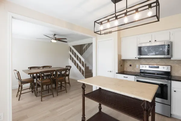 a kitchen with a dining table and chairs