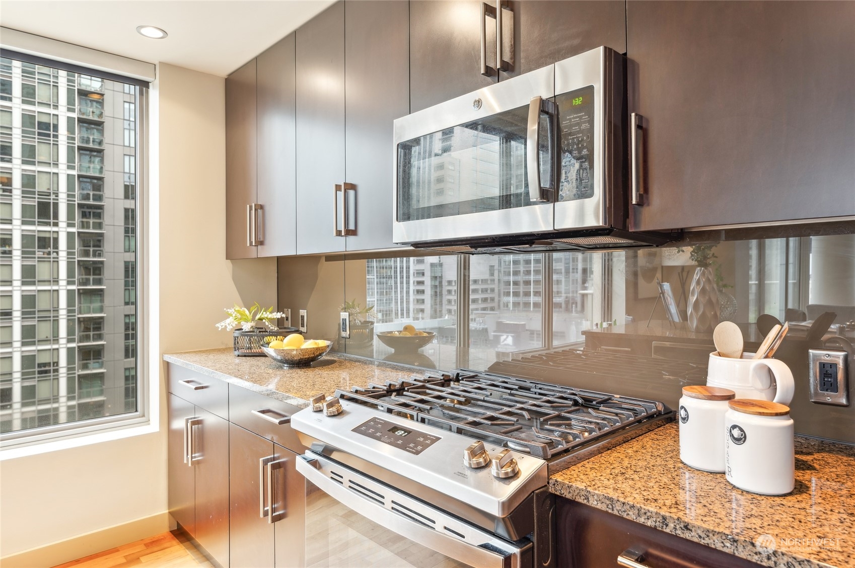 910 Lenora Street, Unit S907 Seattle, WA 98121 - Photo 11 of 38 a stove top oven sitting inside of a kitchen