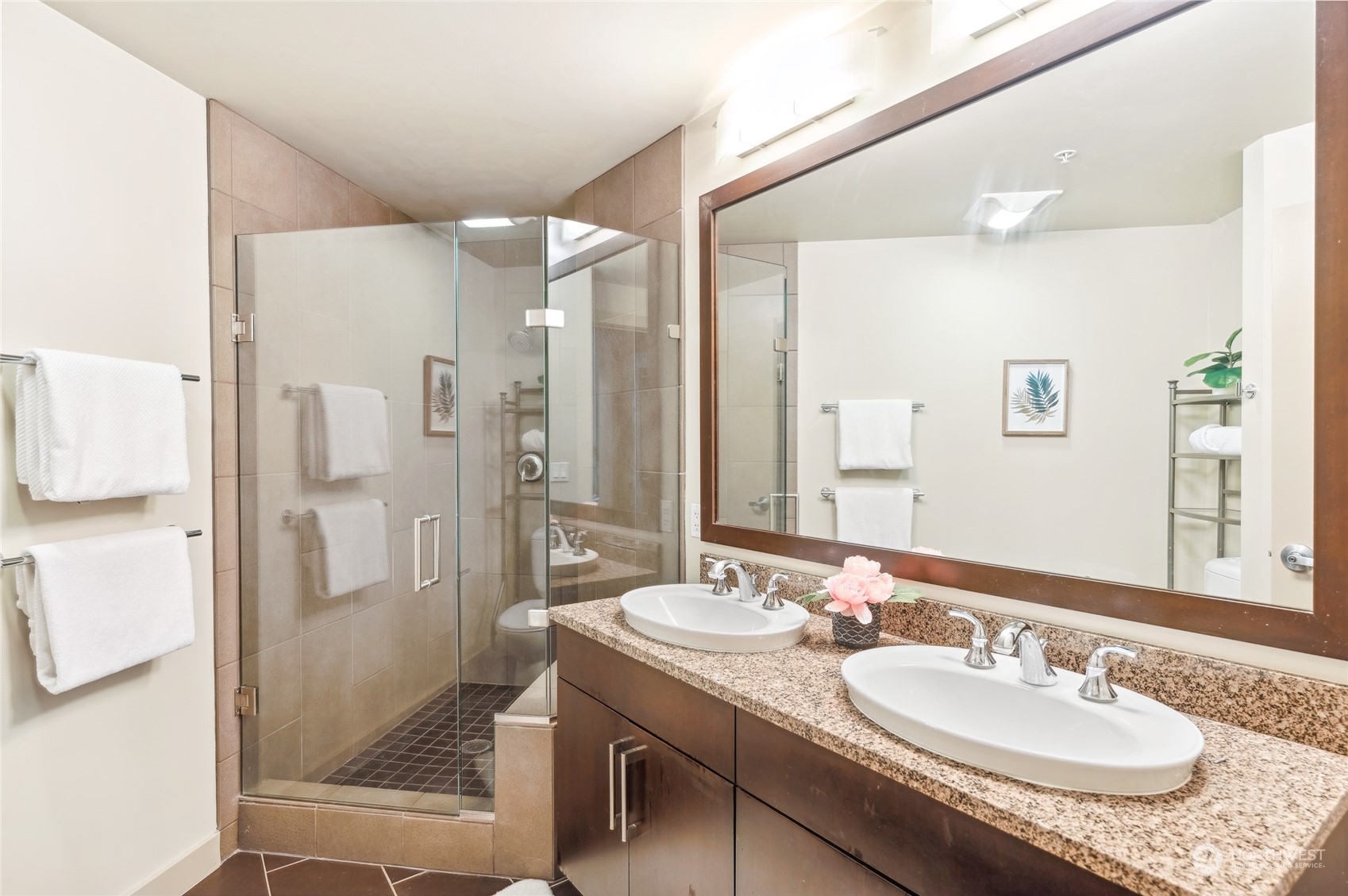 910 Lenora Street, Unit S907 Seattle, WA 98121 - Photo 25 of 38 a bathroom with a granite countertop sink shower and a mirror