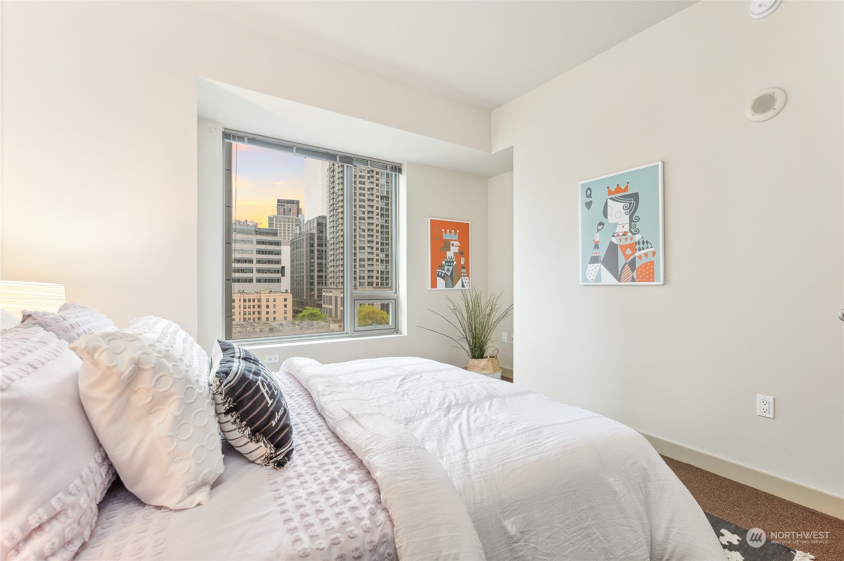 910 Lenora Street, Unit S907 Seattle, WA 98121 - Photo 29 of 38 a bedroom with a large bed and a large window