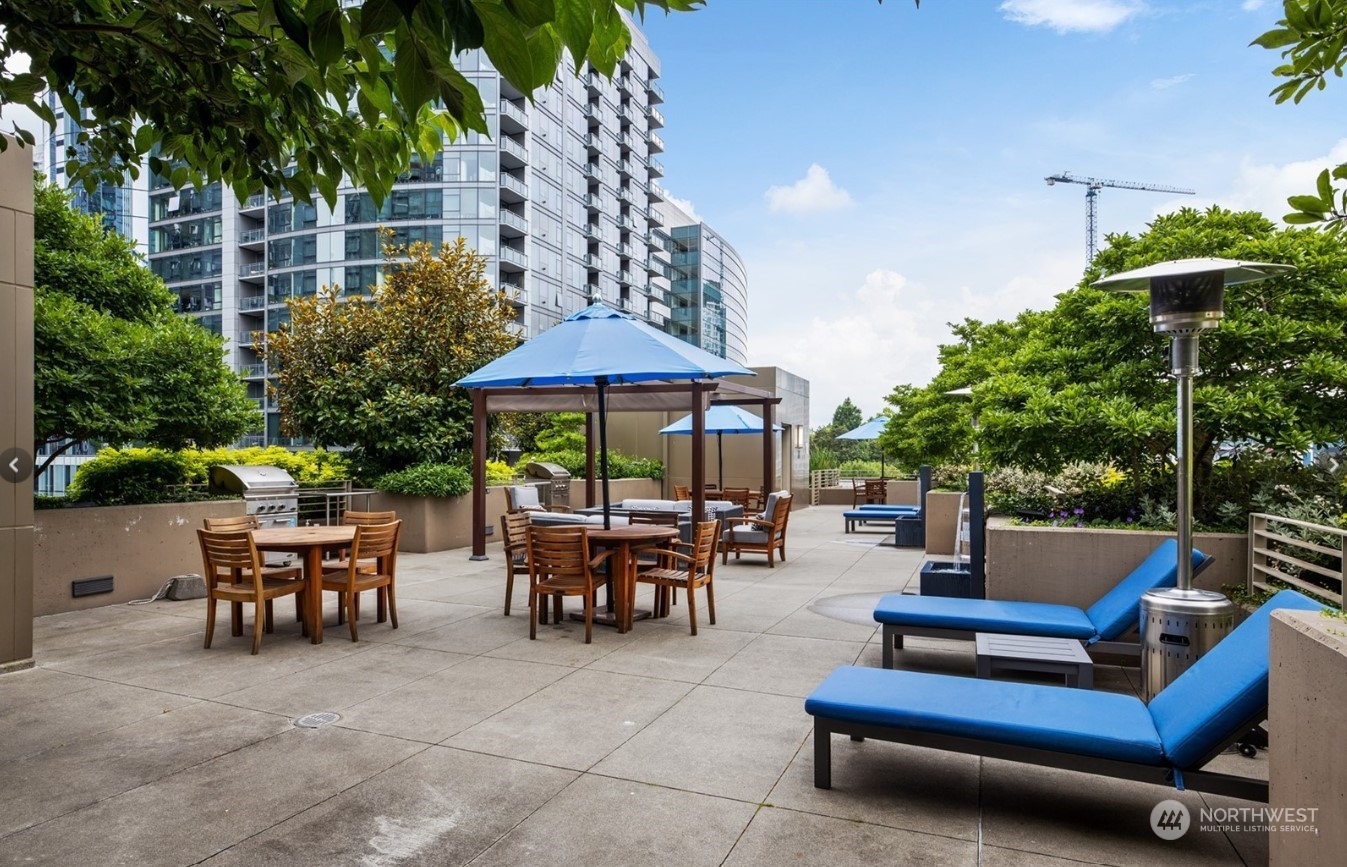 910 Lenora Street, Unit S907 Seattle, WA 98121 - Photo 35 of 38 a outdoor space with patio the couches and a potted plant on the table and a couple of chairs