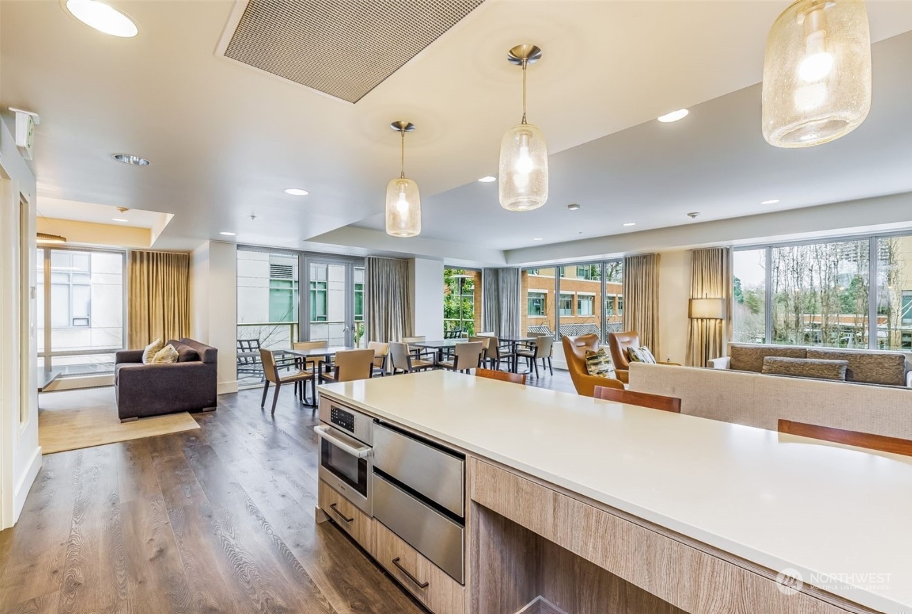 910 Lenora Street, Unit S907 Seattle, WA 98121 - Photo 38 of 38 a large living room with stainless steel appliances granite countertop couches a fireplace with wooden floor