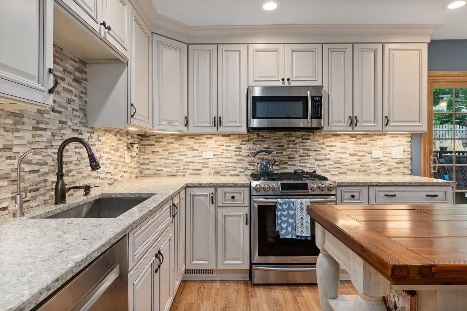6N998 Riverside Drive St. Charles, IL 60174 - Photo 7 of 46 a kitchen with stainless steel appliances granite countertop a sink stove and cabinets