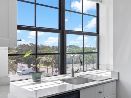 a kitchen with a sink and large window