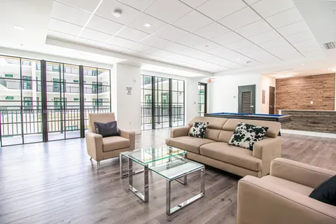 a living room with furniture and a large window