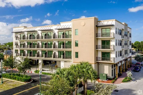 a front view of a building with a garden
