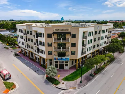 a view of a building with a garden and pathway