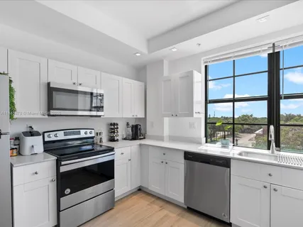 a kitchen with a sink stove and microwave