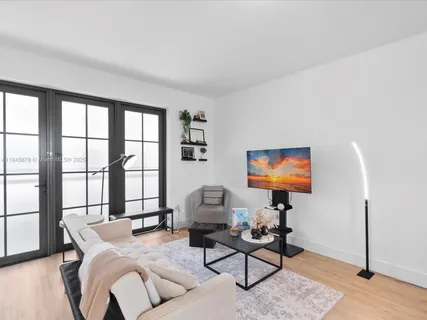 a living room with furniture a rug and a flat screen tv