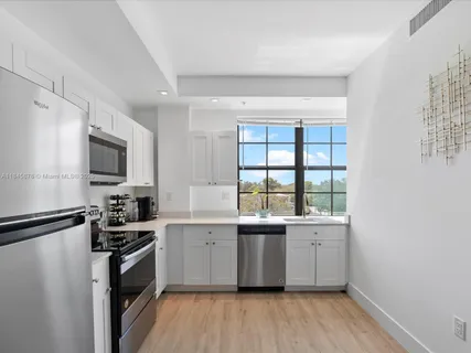 a kitchen with a sink stove and refrigerator