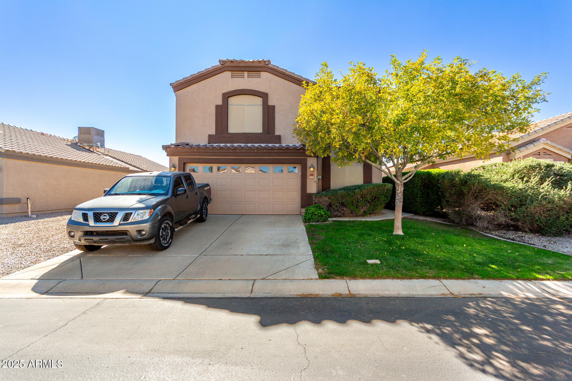 a car parked in front of a house with a garden