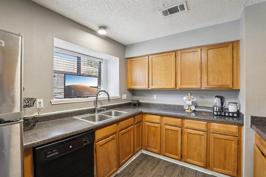102 East Ridgegate Drive Garland, TX 75040 - Photo 12 of 31 a kitchen with sink cabinets and window