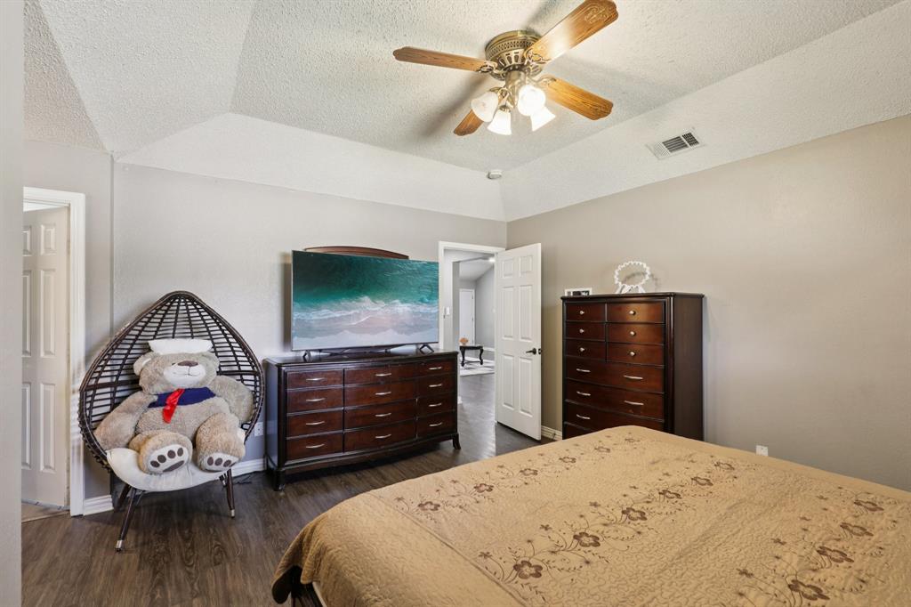 102 East Ridgegate Drive Garland, TX 75040 - Photo 14 of 31 a bedroom with a bed and a dresser