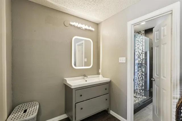 a bathroom with a double vanity sink and a mirror