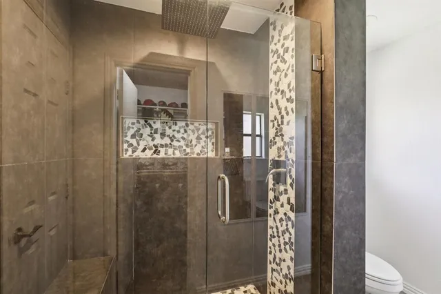 a bathroom with a glass shower door