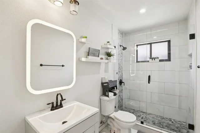 a bathroom with a toilet sink and shower
