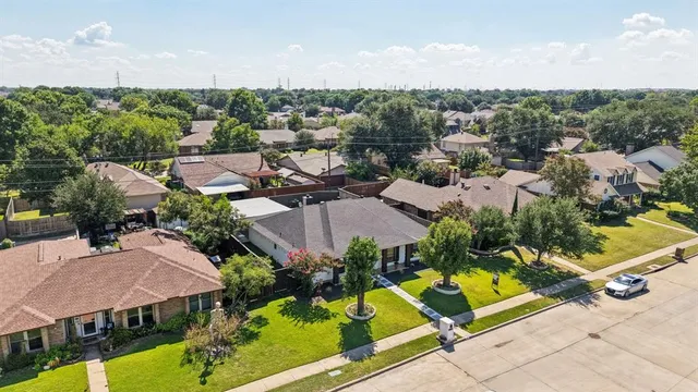 an aerial view of residential house with outdoor space and swimming pool
