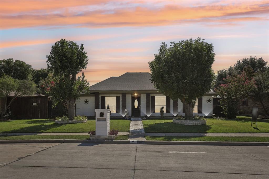 102 East Ridgegate Drive Garland, TX 75040 - Photo 30 of 31 a front view of a house with a yard