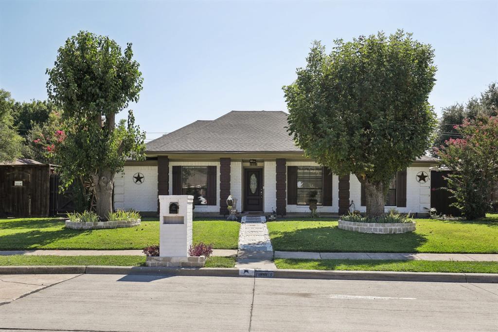 102 East Ridgegate Drive Garland, TX 75040 - Photo 3 of 31 a front view of a house with a yard table and chairs